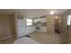 Bright kitchen with white cabinetry, tile flooring, and modern appliances, offering a functional and clean cooking space at 9202 Teak St, New Port Richey, FL 34654