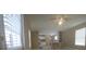 Open-concept living space with tile flooring, neutral walls, and bright windows, connecting living and dining areas at 9202 Teak St, New Port Richey, FL 34654