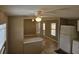 Open-concept living room boasts tile floors, fan, and breakfast bar with view of the kitchen at 9202 Teak St, New Port Richey, FL 34654