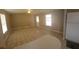 Spacious living room featuring tile flooring, natural light, and a seamless flow into the kitchen area at 9202 Teak St, New Port Richey, FL 34654