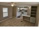 Open living space shows the kitchen, dining, and living area, all with tile flooring and natural light at 9202 Teak St, New Port Richey, FL 34654