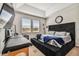Modern bedroom with tray ceilings, a large bed, and a cozy atmosphere at 13201 Orca Sound Dr, Riverview, FL 33579