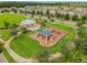 Aerial view of a playground in a green lawn area featuring slides, swings, and climbing equipment at 13201 Orca Sound Dr, Riverview, FL 33579