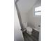 A compact bathroom features a toilet and window, maximizing space and light at 5117 16Th Ave, Gulfport, FL 33707