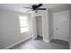 Cozy bedroom with wood-look floors, ceiling fan, closet, and plenty of natural light at 5117 16Th Ave, Gulfport, FL 33707