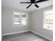 Neutral bedroom featuring modern flooring, a ceiling fan, and bright natural light at 5117 16Th Ave, Gulfport, FL 33707