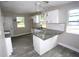 Modern kitchen with white cabinets, granite countertops, and stainless steel appliances at 5117 16Th Ave, Gulfport, FL 33707