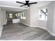 Open-concept living room with new flooring and plenty of natural light, flowing into the kitchen at 5117 16Th Ave, Gulfport, FL 33707