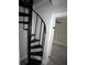 A black spiral staircase leads to upper floors, adding architectural interest to the home at 5117 16Th Ave, Gulfport, FL 33707