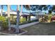 Lush landscaping surrounds this beautiful single-story home with well-maintained lawn and an American flag at 891 Island Way, Clearwater Beach, FL 33767