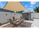 Cozy backyard featuring a brick patio with chairs and a fire pit under a shade sail at 4444 5Th S Ave, St Petersburg, FL 33711