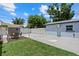 Backyard area features a shed, white fence, concrete, and a small patch of grass at 4444 5Th S Ave, St Petersburg, FL 33711