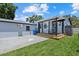 Backyard with a covered porch featuring black trim, a table with chairs, and a lush green lawn at 4444 5Th S Ave, St Petersburg, FL 33711