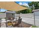 Backyard sitting area with a fire pit, shed and patio beneath a shade sail at 4444 5Th S Ave, St Petersburg, FL 33711