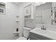 This bright bathroom offers tile flooring, a shower, and white cabinets at 4444 5Th S Ave, St Petersburg, FL 33711