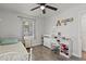 Cozy bedroom featuring desk and chair, laminate flooring, and natural light at 4444 5Th S Ave, St Petersburg, FL 33711