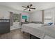 Sunlit bedroom with a ceiling fan, and windows dressed with curtains and blinds at 4444 5Th S Ave, St Petersburg, FL 33711