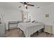 Sunlit bedroom with a ceiling fan, and two windows dressed with curtains and blinds at 4444 5Th S Ave, St Petersburg, FL 33711