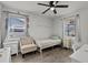 Bright bedroom with laminate flooring, two windows with blinds, and a small vanity at 4444 5Th S Ave, St Petersburg, FL 33711