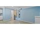 Bedroom with light blue walls, AC unit, wood-look floors and neutral-colored window treatment at 4444 5Th S Ave, St Petersburg, FL 33711