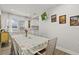 Open dining room with a decorative table set for six, and a TV mounted to the wall at 4444 5Th S Ave, St Petersburg, FL 33711