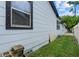 Exterior view of the home showing the light-gray siding and black trim details at 4444 5Th S Ave, St Petersburg, FL 33711