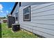 Home exterior showcasing light-gray siding, black trim, an air conditioner, and a shed at 4444 5Th S Ave, St Petersburg, FL 33711