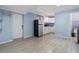Kitchen and dining area with stainless steel appliances, white cabinets and tile floors at 4444 5Th S Ave, St Petersburg, FL 33711