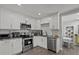 Modern kitchen featuring stainless steel appliances and white cabinetry at 4444 5Th S Ave, St Petersburg, FL 33711