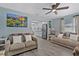 Inviting living room with grey floors, light blue walls, and modern ceiling fan at 4444 5Th S Ave, St Petersburg, FL 33711