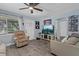 Inviting living room with grey floors, light blue walls, and modern ceiling fan at 4444 5Th S Ave, St Petersburg, FL 33711