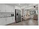 Open-concept living room with great view into the bright white kitchen at 4444 5Th S Ave, St Petersburg, FL 33711