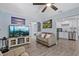 Inviting living room with grey floors, light blue walls, and modern ceiling fan at 4444 5Th S Ave, St Petersburg, FL 33711