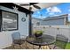 Covered outdoor patio features a ceiling fan and table with two chairs at 4444 5Th S Ave, St Petersburg, FL 33711