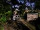 Secluded backyard featuring a vintage camper and storage shed, surrounded by lush greenery and privacy trees at 917 E 15Th Ave, Tampa, FL 33605