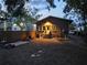 Cozy backyard featuring a well-lit home exterior with a wooden fence and ample space at 917 E 15Th Ave, Tampa, FL 33605