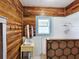 Cozy bathroom with wood paneled walls, hexagonal tile shower and pedestal sink at 917 E 15Th Ave, Tampa, FL 33605