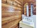 Bathroom with wood accent wall, round mirror, and unique sink at 917 E 15Th Ave, Tampa, FL 33605