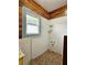 Unique bathroom with charming shower, decorative tiling and beautiful wood ceiling and wall accents at 917 E 15Th Ave, Tampa, FL 33605