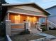 Charming single-story home at dusk, featuring a covered front porch with warm lighting and inviting curb appeal at 917 E 15Th Ave, Tampa, FL 33605