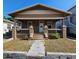 Charming single-story home featuring a covered front porch with brick supports and inviting curb appeal at 917 E 15Th Ave, Tampa, FL 33605