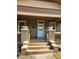 Inviting front porch with brick supports, decorative planters, and a freshly painted white front door at 917 E 15Th Ave, Tampa, FL 33605