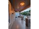 Expansive covered front porch with vintage lighting, brick supports, and a welcoming outdoor space at 917 E 15Th Ave, Tampa, FL 33605