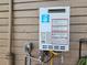 On-demand hot water heater on the exterior of the house at 917 E 15Th Ave, Tampa, FL 33605