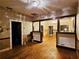 Living room featuring hardwood floors, exposed walls, and an elegant ceiling fixture with lots of space at 917 E 15Th Ave, Tampa, FL 33605