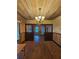 View of the living room showcasing hardwood floors, and a stylish ceiling fixture and lots of space at 917 E 15Th Ave, Tampa, FL 33605