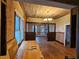 Spacious living room featuring original hardwood floors and decorative ceiling fixture; perfect for entertaining at 917 E 15Th Ave, Tampa, FL 33605