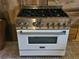 Close up of ZLINE oven with stainless steel cooktop and white body at 917 E 15Th Ave, Tampa, FL 33605