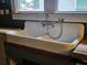 Oversized white vintage sink with chrome fixtures and wood base at 917 E 15Th Ave, Tampa, FL 33605