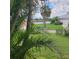 Backyard featuring landscaping, a fence, and tranquil water views at 4611 Herman Cir, Port Charlotte, FL 33948